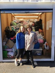 Sophomore Leah Mautner and Head of The Bloom Closet Beck Davenport stand in front of the Pace donations. Photo: Becky Mautner