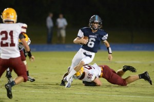Sophomore QB Gunnor Faulk uses his mobility to gash the Golden Bears for a big gain on the ground. Photo Credit: Fred Assaf