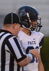Sophomore, game day captain, Jonathan Tennies waits eagerly has the referees flip the coin. Photo: Fred Assaf