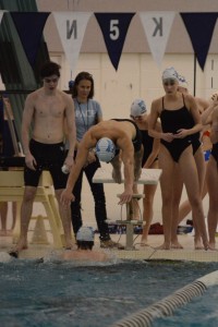 Seniors Madison Graham and Harrison Ray look on as their teammate dives into the pool Photo: Fred Assaf