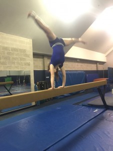 Junior Emma Downey performs on the balance beam.