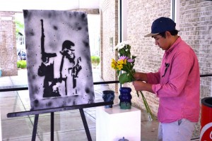 Senior Aaron Davis sets up his work at the advance studio art show. Photo: Dori Greenberg