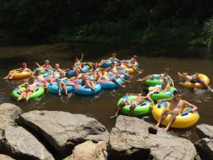 Pace cross country runners enjoy tubing down the river at their camp over the summer.