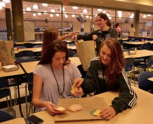 Freshmen Ada Jane Agoli and Lucy Ferry make sandwiches for the Zaban Paradeis Center. Photo: Genna Schwarz