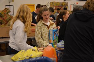 Sophomore Lily Wagoner helps sort food at the Atlanta Community Food Bank on Service Day a year ago. Photo: Lee Wilson