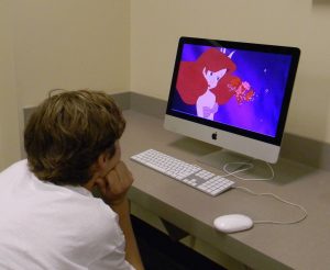 Freshman Matthew Friestad watches the Disney movie, Ariel.