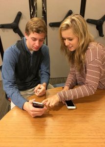 Junior Harrison Lewis shows off his new camera to junior Emme Maner. Photo: Margaret Bethel