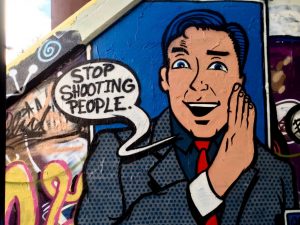 Street art under the Krog Street bridge reads "Stop Shooting People." Photo: Alexis Wilkins