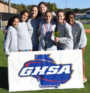 The girls cross country team revels in their 3rd place finish at State. Photo: Fred Assaf